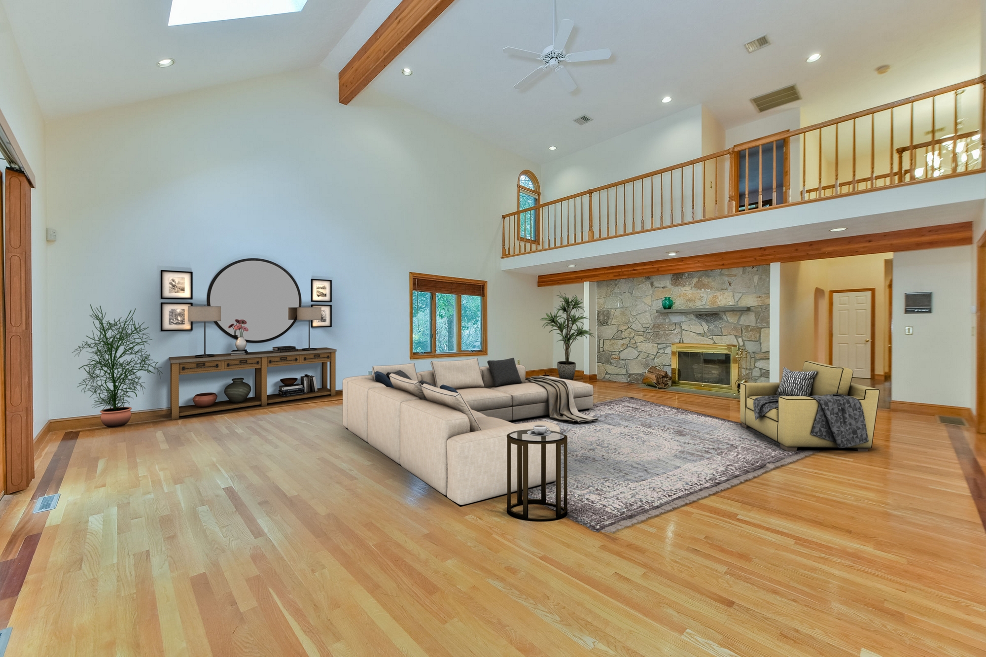 Skylit 2 story Great Room with fireplace, balcony